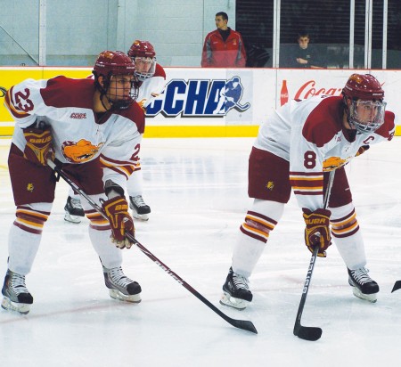 Ice Hockey: Sophomore Michael Trebish (#23) and senior Cody Chupp (#8) stand ready for the face-off at a recent game. The Bulldogs ended the season with a 21-13-6 overall record, tying with the previous fourth place record for number of wins by a Ferris State ice hockey team. Photo By: Kristyn Sonnenberg | Photo Editor